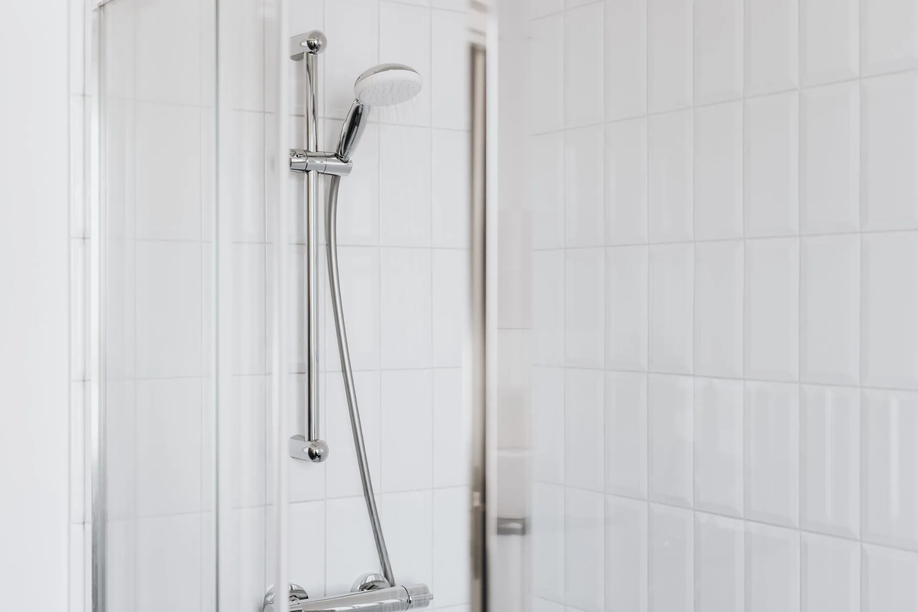 The same shower with clear glass and white grout